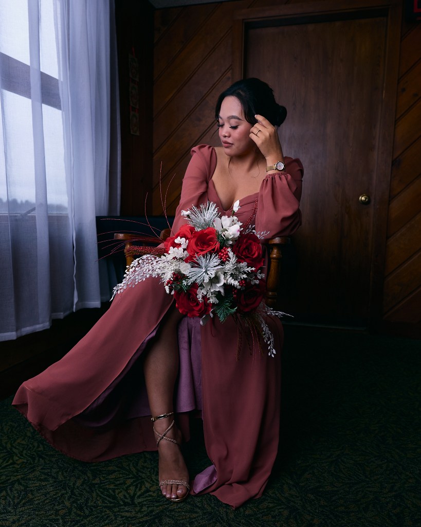 Bride posing in chair with bouquet