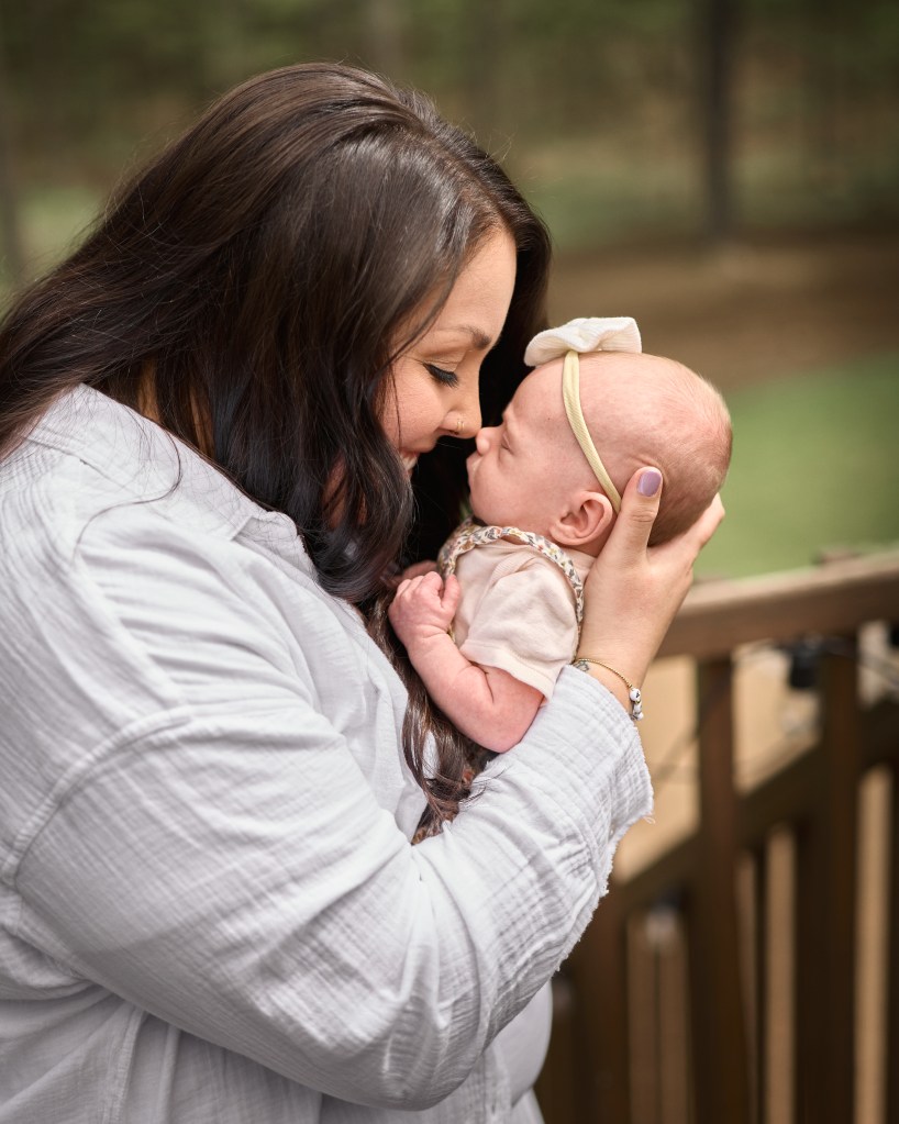 Cute Family Photo of Mother and Newborn rubbing noses together