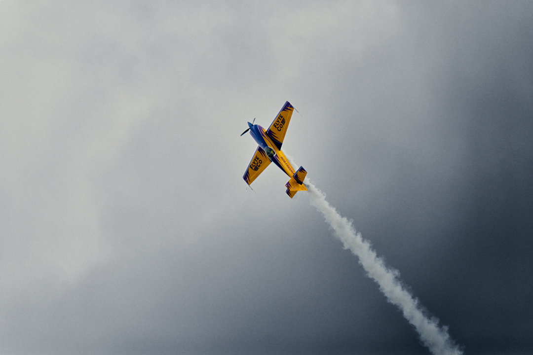 Airplane with smoke trail doing tricks at EAA air show in oshkosh wisconsin